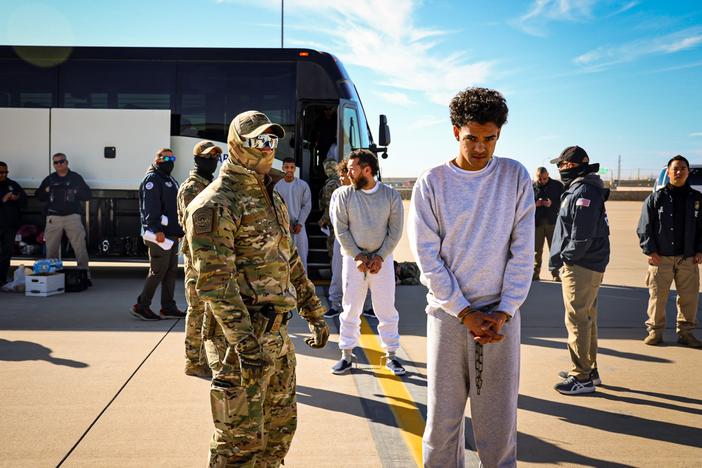 The Department of Homeland Security released photos of migrants as they boarded planes for Guantánamo Bay, Cuba.