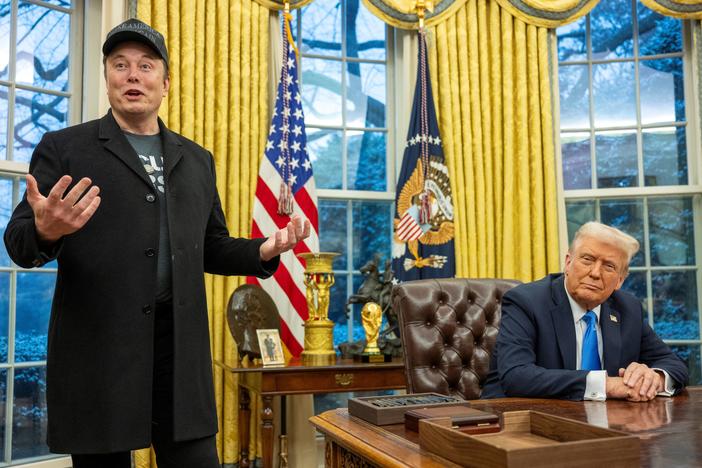 Elon Musk speaks as President Trump looks on in the Oval Office of the White House on Feb. 11.