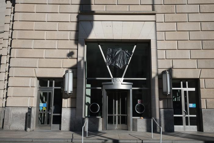 Workers removed the sign at the U.S. Agency for International Development building on February 7.