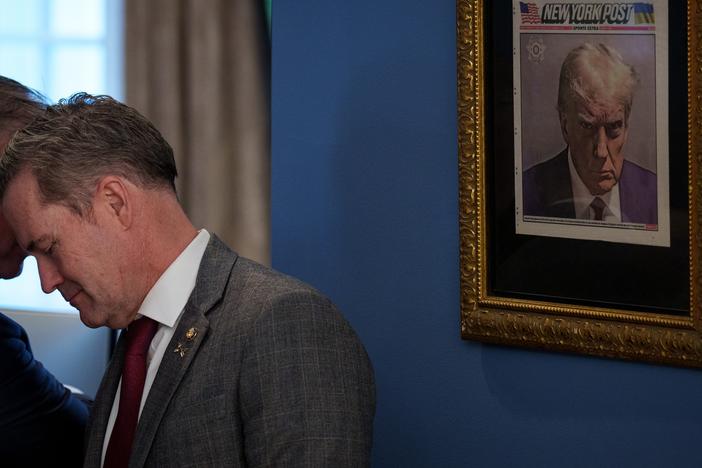 A copy of Donald Trump's mug shot on the cover of the <em>New York Post</em> is framed in an office just outside the Oval Office.