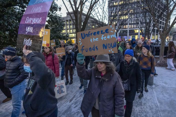 People protest near the White House in Washington on Jan. 28. against a funding freeze of federal grants and loans following a push from President Trump to pause federal funding.