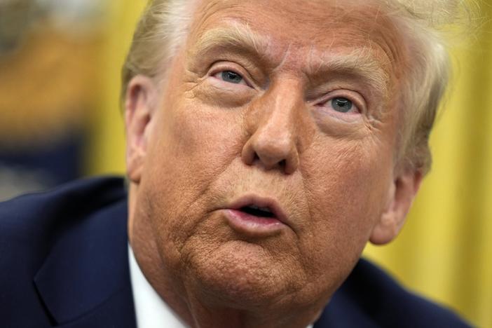 President Donald Trump talks to reporters as he signs executive orders in the Oval Office of the White House on Jan. 23, 2025, in Washington.