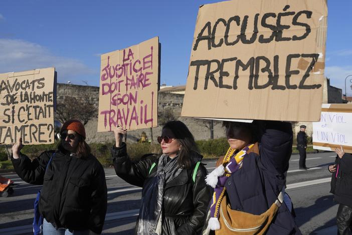 Activists hold posters during a women's rights demonstration, Dec. 14, 2024 in Avignon, southern France, where the trial of dozens of men accused of raping Gisèle Pelicot while she was drugged and rendered unconscious by her husband is taking place.