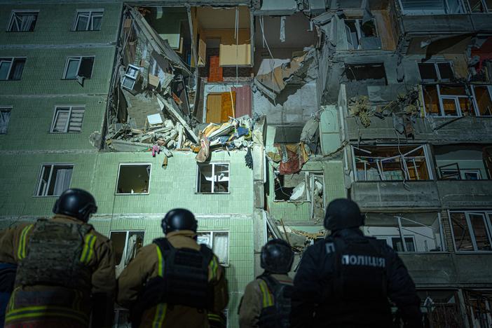 A rescue team gathers in front of a damaged residential building in Sumy just after a Russian drone strike that destroyed nine apartments and killed 11 people, Jan. 30.
