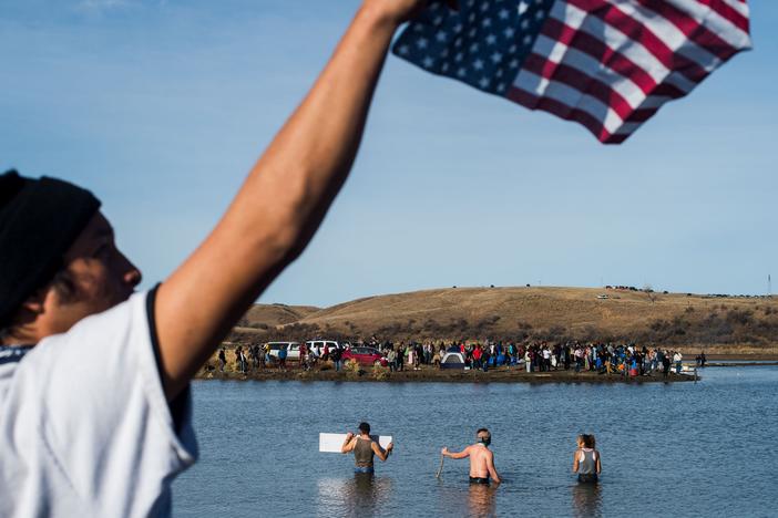 Protesters wade in the Cannon Ball River during a standoff with the police at Turtle Island north of the Standing Rock Reservation in North Dakota, on Nov. 2, 2016.