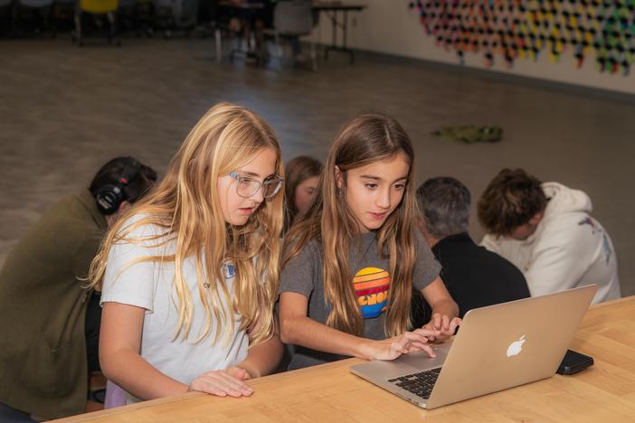 Fifth graders Kenley Taylor (left) and Gabby De Sa (right) work on story outlining during a MagTV morning meeting at Magnolia Elementary School in Carlsbad, Calif.