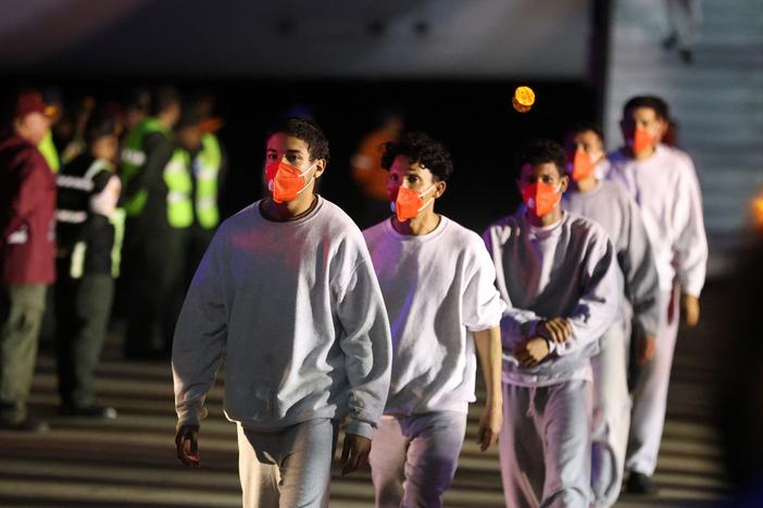 Venezuelan migrants deported from US Naval Station Guantanamo Bay walk down from the Venezuelan Conviasa Airlines plane as they arrive at Simon Bolivar International Airport in Maiquetia, Venezuela on February 20, 2025.