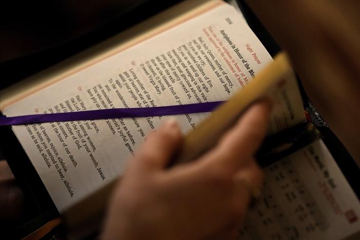 A college student looks through her prayer book. A new study found a decline in Christianity in the U.S.  (AP Photo/Charlie Riedel)