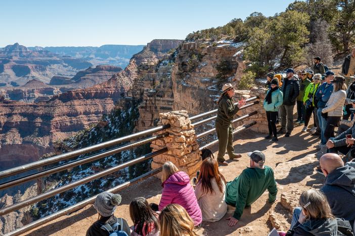 A ranger gives a tour to visitors at Grand Canyon National Park on Saturday. The National Park Service is dealing with the effects of layoffs and the federal hiring freeze.