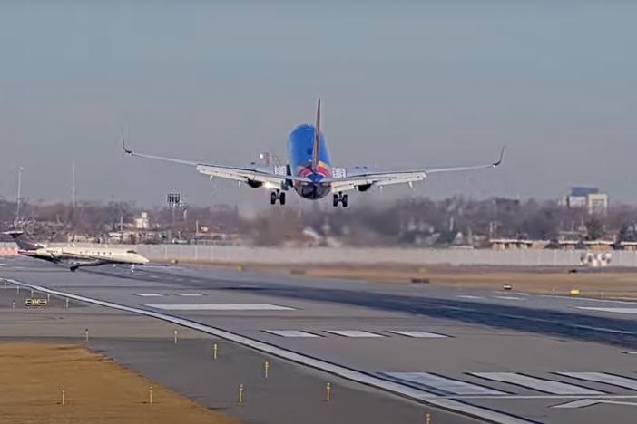 A screenshot from the StreamTime Live account on YouTube of the near-collision between a Southwest 737 plane and a private business jet at Chicago's Midway Airport. The 737 flight was arriving from Omaha, Neb. when the business jet mistakenly crossed the runway.