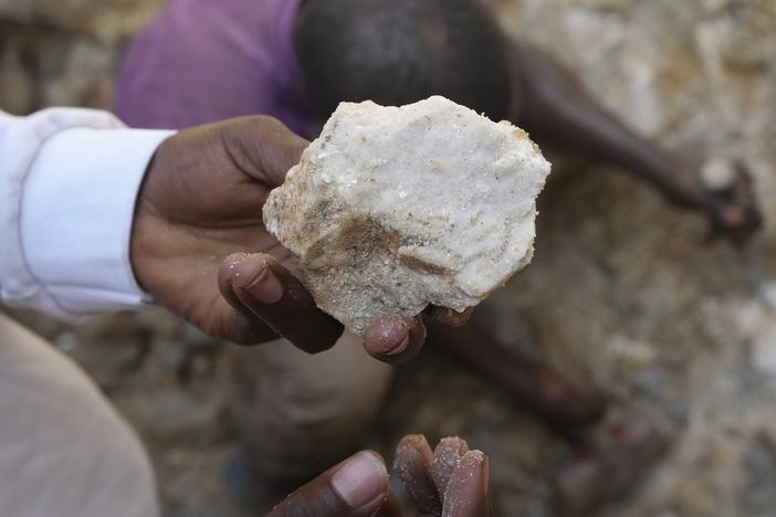 A man shows lithium stone from an illegal mining site in Paseli, north central Nigeria, Tuesday, Nov 5, 2024.