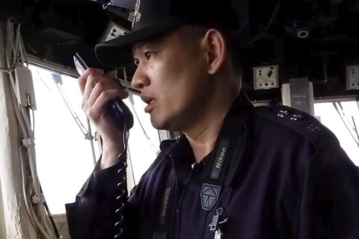 In this image taken off a video released by the Taiwan Ministry of National Defense, a member of Taiwan Navy reacts on the intercom to Chinese war ships conducting drills about 40 nautical miles off the coast of western Taiwan's Kaohsiung and Pingtung cities on Feb. 26, 2025.