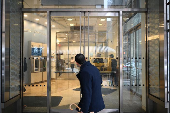 A man walks past a branch of Signature Bank in New York City on March 13, 2023. After Signature Bank collapsed during the 2023 regional banking crisis, the Federal Deposit Insurance Corp. said it didn't have enough qualified examiners to catch the problems that had led to the bank's failure.