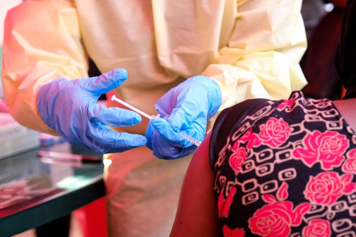 A member of a medical team at Mulago Referral Hospital in Kampala, Uganda, administers a dose of a trial Ebola vaccine to a patient on Feb. 3. The country is currently experiencing an Ebola outbreak.