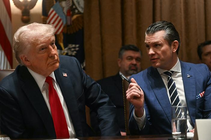 President Trump looks on as Defense Secretary Pete Hegseth speaks during a cabinet meeting at the White House on Wednesday.