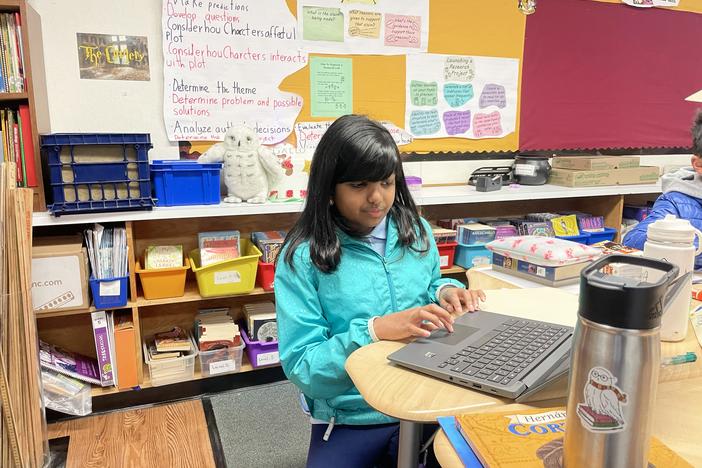 Fifth grader Ameya Desai works at her research project that she's presenting to her class at Williams Elementary School in San Jose, Calif. Her podcast about her grandfather's immigration story was one of the fourth grade winners in the 2024 NPR Student Podcast Challenge.