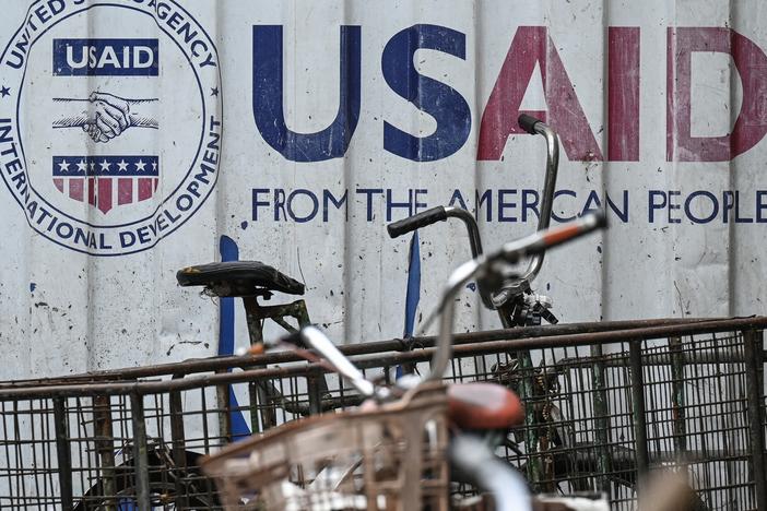 Signage for the US government's humanitarian agency USAID is seen on a cargo container beside a tricycle in Manila on Feb. 4.