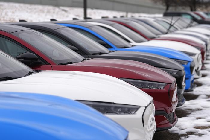 Mustang Mach-E electric vehicles sit in a long row at a dealership on Jan. 21, 2024. Some customers who bought electric vehicles in 2024 are not able to access an EV tax credit now, because their dealers did not report the sale to the IRS using a new system.