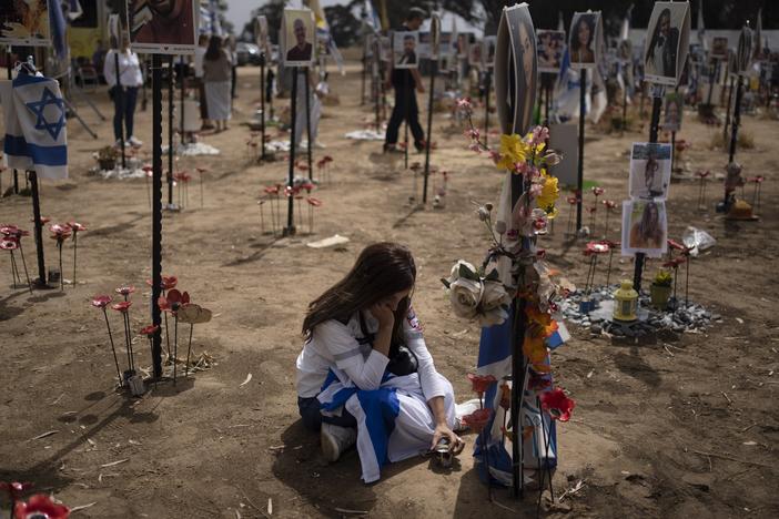 A woman grieves at a memorial for those killed and abducted during the Oct. 7, 2023, cross-border attack by Hamas militants, near the kibbutz Reim, southern Israel on May 13, 2024.