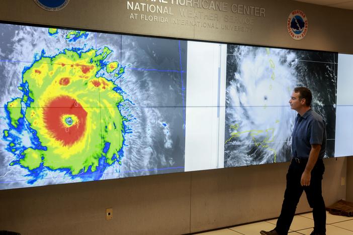 A hurricane specialist looks at a satellite image of Hurricane Beryl, the first hurricane of the 2024 season. The National Hurricane Center provides forecasts of major storms, many of which make landfall in the U.S.. The Center is part of NOAA, the country's oceans- and atmosphere-focused agency. Experts say ongoing staff cuts at the agency could endanger some of its core missions, like forecasting weather.