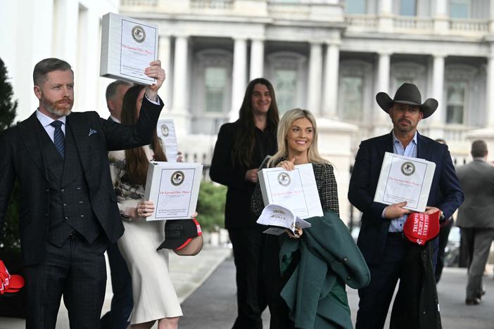 (From L) Political commentator Rogan O'Handley, aka DC Draino, TikToker Chaya Raichik, conservative activist Scott Presler, commentator Liz Wheeler and conservative political commentator Chad Prather carry binders containing Jeffrey Epstein files out of the White House on Thursday.
