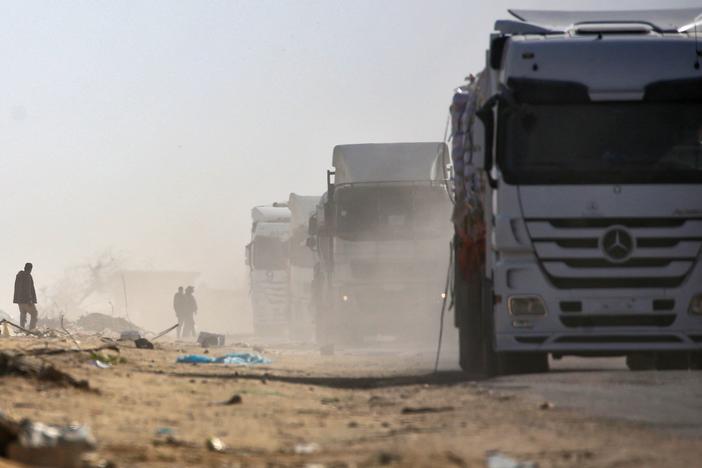 Trucks loaded with humanitarian aid drive through Rafah in the southern Gaza Strip after entering from the Kerem Shalom crossing on February 18, 2025.