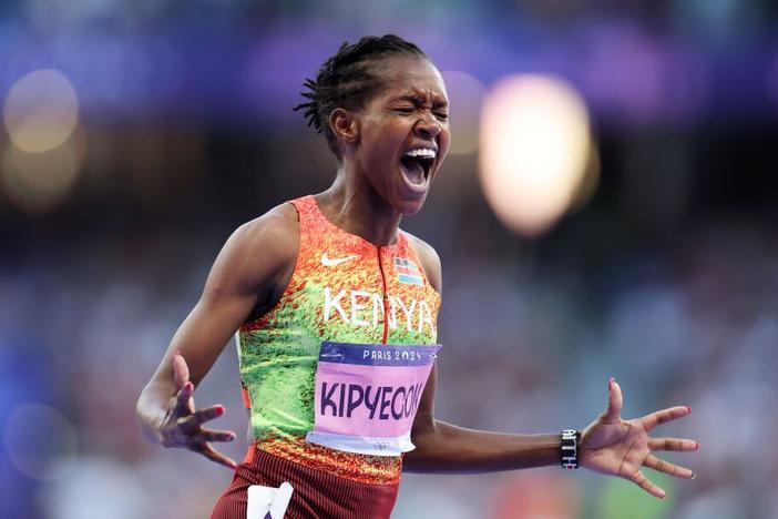 Faith Kipyegon of Team Kenya celebrates winning the Gold medal and setting a new Olympic record in the Women's 1500m Final in August, 2024 in Paris.