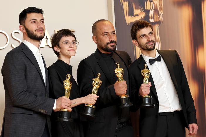 From left: Basel Adra, Rachel Szor, Hamdan Ballal and Yuval Abraham pose with their Oscar awards for best documentary for the film <em>No Other Land</em> in the press room at the 97th Academy Awards in Los Angeles on Sunday.