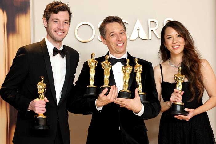 Alex Coco, left, Sean Baker and Samantha Quan pose in the press room with their Oscars for <em>Anora.</em>