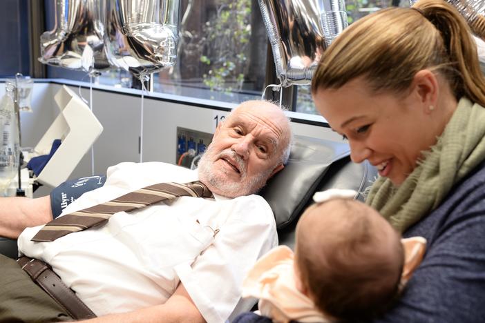 James Harrison looks at 8-month-old Layla and her mother, Beth Ismay, in Sydney, Australia, in May 2018. It was the last time Harrison donated blood.