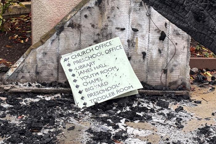 A sign at Palisades Presbyterian Church sits among the charred remains of the buildings.