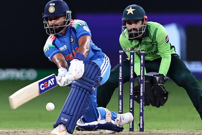 India's Shreyas Iyer (left) plays a shot as Pakistan's wicketkeeper captain Mohammad Rizwan watches during the ICC Champions Trophy one-day international cricket match between Pakistan and India at the Dubai International Stadium on Feb. 23.