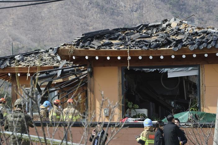 Rescue members work at a bomb accident site where a South Korean fighter jet accidentally dropped bombs on a civilian area during training, in Pocheon, South Korea, Thursday, March 6, 2025. (Yonhap via AP)
