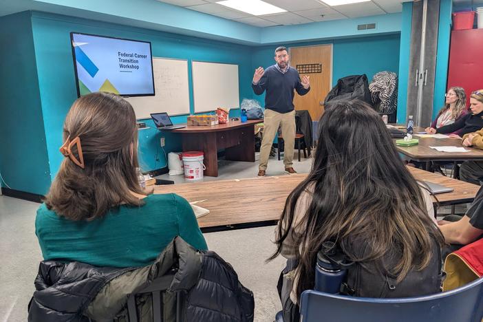 Workshop organizer Charlie Elison talks to newly laid off federal workers gearing up for the job hunt.