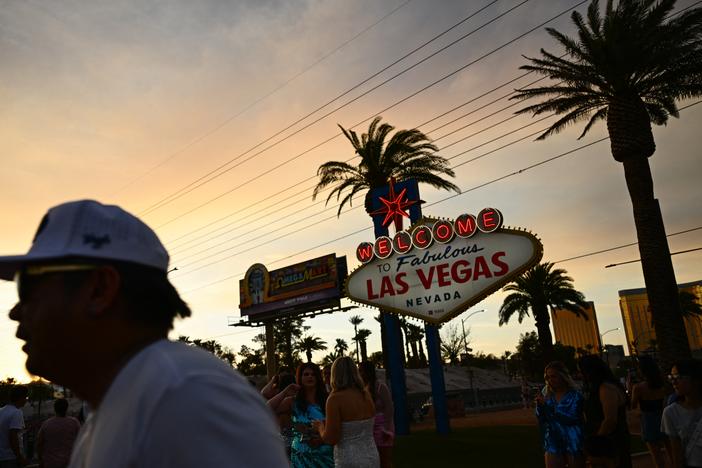People take pictures with the Las Vegas sign in that city on July 29, 2023. Tourism industry leaders warn that recent actions by the Trump administration may be causing a drop in Canadians traveling to the U.S.