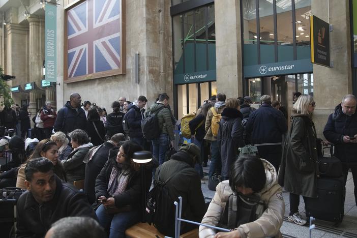 Travelers wait as Eurostar trains to London and all trains heading to northern France have been brought to a halt following the discovery of an unexploded bomb dating back to World War II near the tracks on Friday, March 7, 2025, at the Gare du Nord station in Paris.
