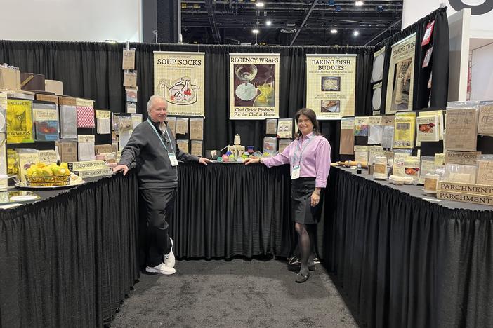 Doug and Lori Cohen, the husband and wife team that owns and runs the Dallas-based Regency Wraps, in front of their company's display space at the Inspired Home Show in Chicago.