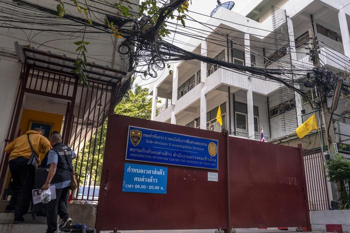 Police enter an immigration detention centre in Bangkok on Jan. 22.