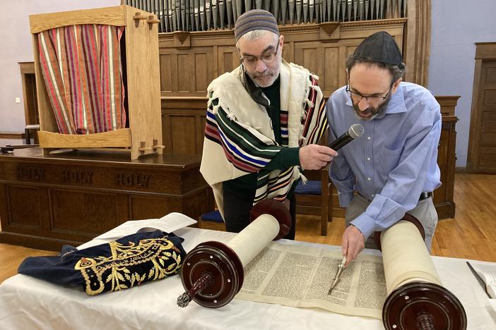 Sholom Sandalow reads from the Torah as Rabbi Brant Rosen watches on a Saturday morning Shabbat service with Tzedek Chicago, an anti-Zionist congregation.