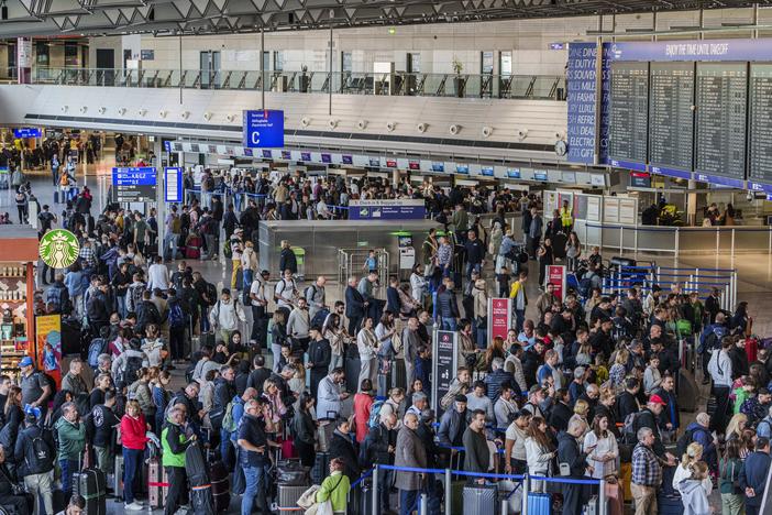 People queue in long lines in departure hall C at Rhine-Main Airport, Frankfurt, Germany on Sunday, a day ahead of a planned strike across Germany amid new contract negotiations.