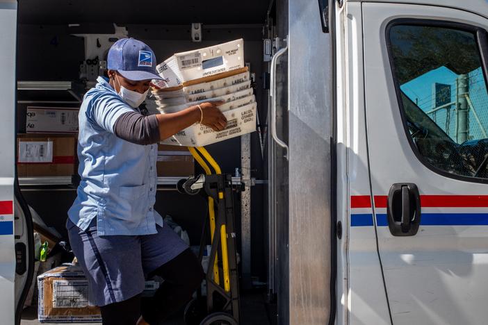 A U.S. Postal Service employee unloads mail at a facility in 2022 in Houston.