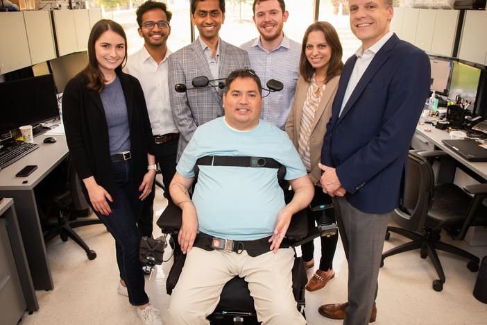 Keith Thomas, who lives with paralysis, poses with the research team at Northwell Health's Feinstein Institutes for Medical Research that worked with him for months to restore lasting movement and feeling in his arm and hand. The 'double neural bypass' system uses brain implants and artificial intelligence to allow signals to and from Thomas' brain to bypass the site of his injury.