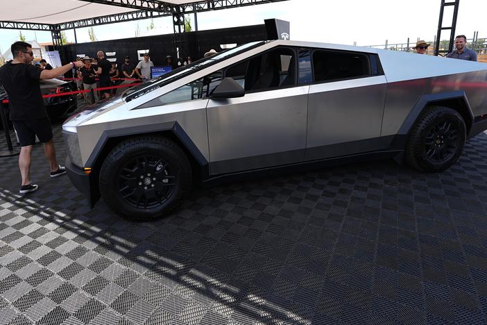 Visitors look over a 2024 Cybertruck in the Tesla display at the Electrify Expo, last July.