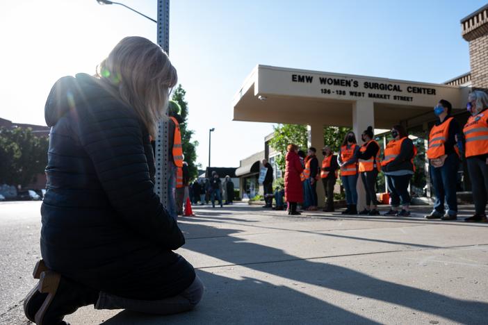 Abortion-rights advocates think the Trump administration's limits on enforcing the FACE Act give a green light to anyone who wants to disrupt abortion centers in the future. Here, an anti-abortion demonstrator is shown before a line of volunteer clinic escorts in front of the EMW Women's Surgical Center, an abortion clinic, in 2021 in Louisville, Kentucky.