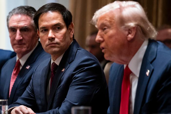 Secretary of State Rubio (center) flanked by Doug Burgum, secretary of the interior, and President Donald Trump during a cabinet meeting on Feb. 26. On Monday, Rubio posted on X that 83% of USAID contracts had been canceled following a review.