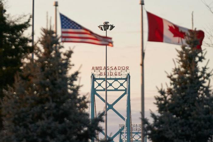 Canadian and American flags fly on the Canadian side of the Ambassador Bridge in Windsor, Ontario, on March 8.