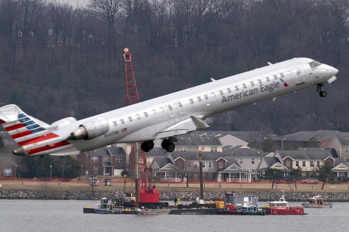 Salvage crews work on recovering wreckage near the site in the Potomac River of a mid-air collision between an American Airlines jet and a Black Hawk helicopter at Ronald Reagan Washington National Airport, Thursday, Feb. 6, 2025, in Arlington, Va.
