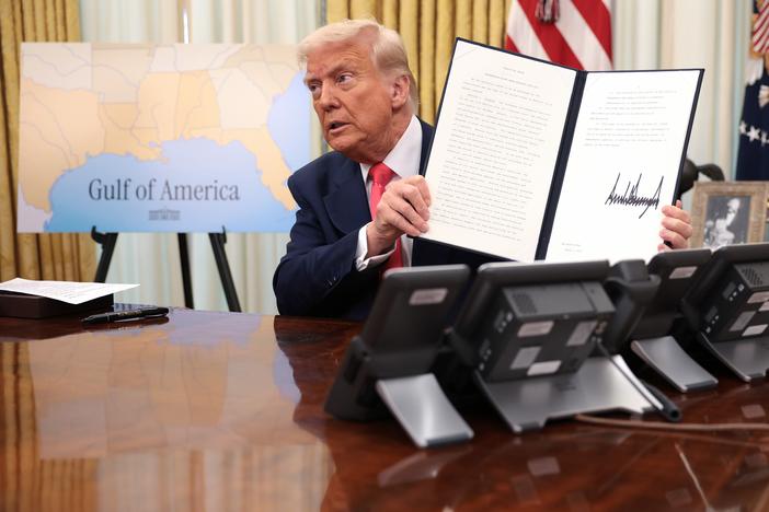 President Trump signs executive orders in the Oval Office on March 6, including the order terminating the security clearances of those who work at the law firm Perkins Coie.
