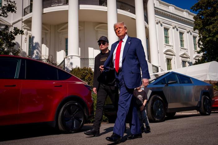 President Trump and White House senior adviser, Tesla and SpaceX CEO Elon Musk depart after looking at Tesla vehicles on the South Lawn of the White House on Tuesday.