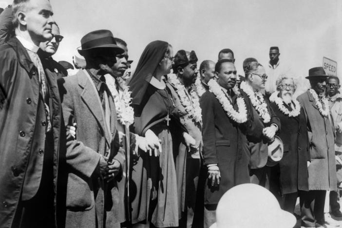Civil rights demonstrators, led by Dr. Martin Luther King (5th R), civil rights activist Ralph Abernathy (5th L), John Lewis (3rd L) and other civil and religious leaders, make their way from Selma to Montgomery on March 22, 1965 in Alabama.